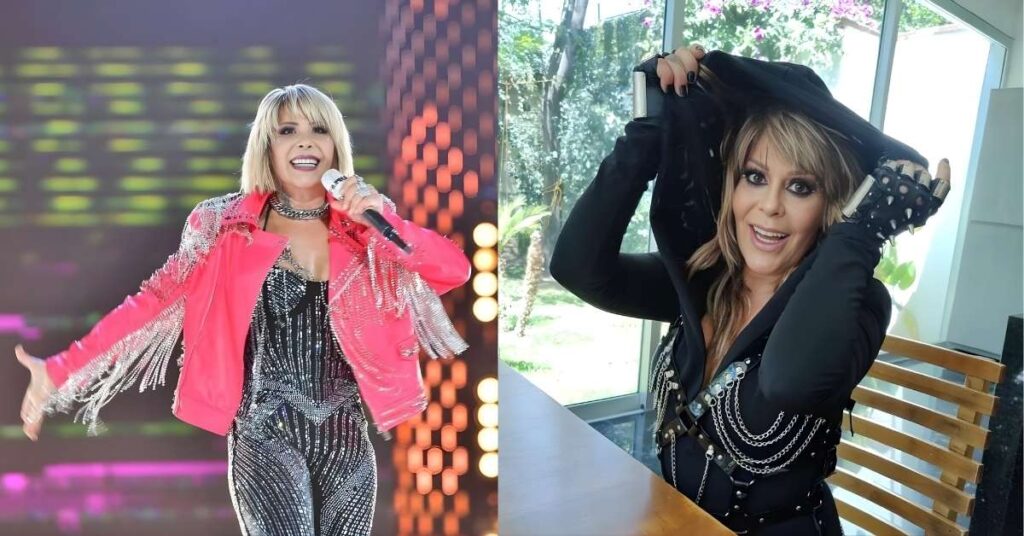 A performer in a sparkly silver jumpsuit and a bright pink jacket with silver fringe,