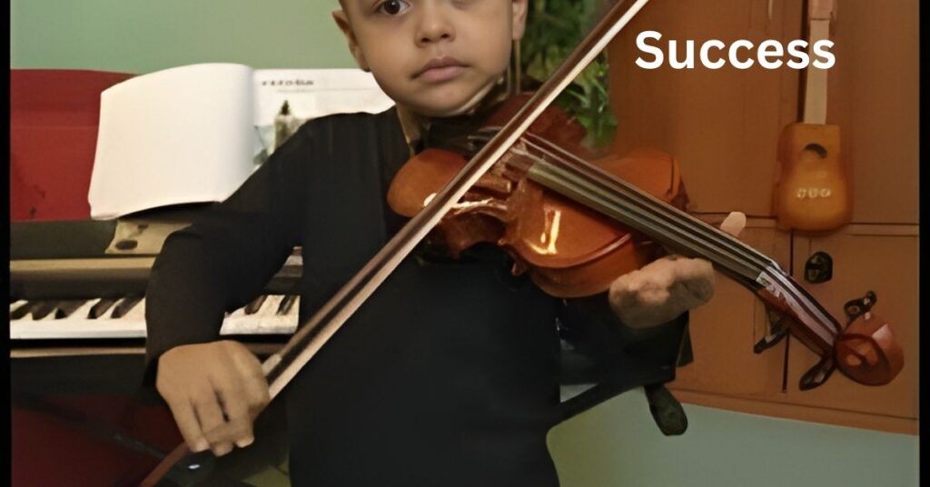 A person plays the violin in front of a keyboard and a ukulele hanging on the wall.
