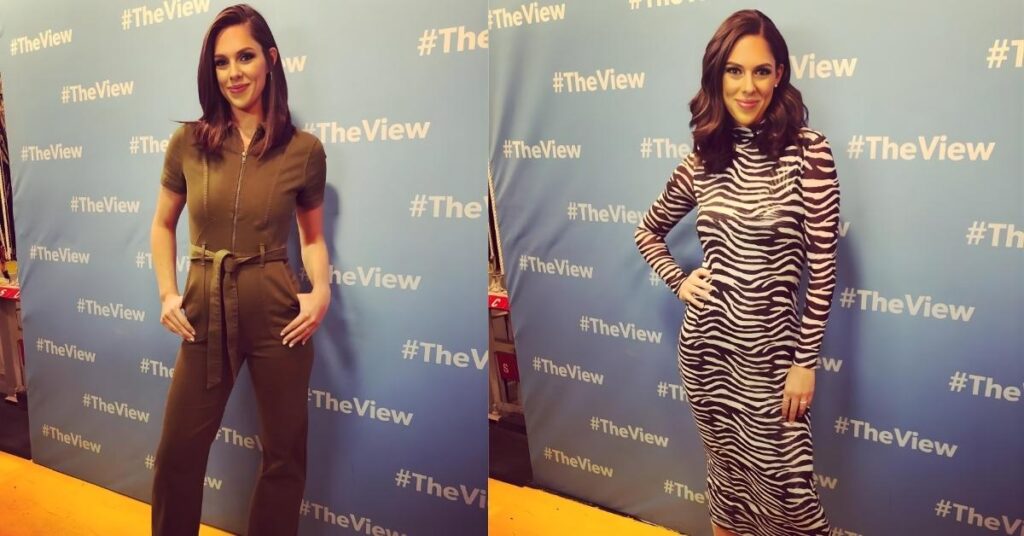 A person poses in front of a blue backdrop