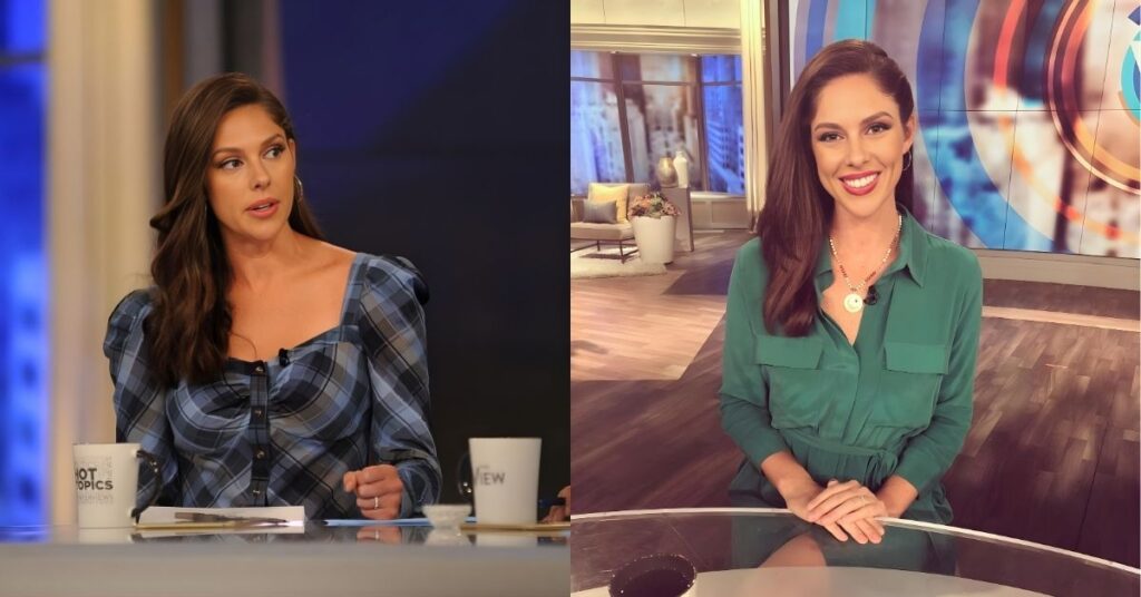 A person sits at a table with mugs and papers, wearing a blue plaid top.