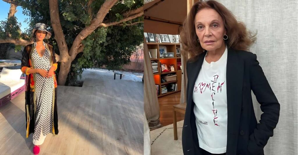 A person wearing a patterned dress, a long patterned robe, a bucket hat, and bright pink shoes stands outdoors near a tree.