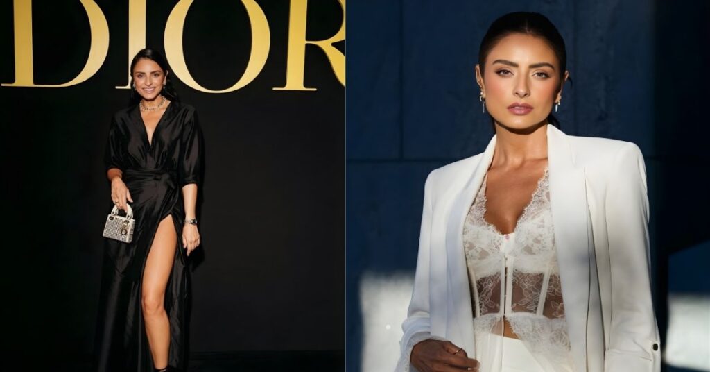 A person wearing a white blazer over a white lace corset and white pants, with sunlight hitting their face and the left side of their body.