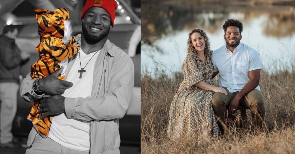 Alfred Morris, in a red beanie, holds a baby dressed as a tiger.