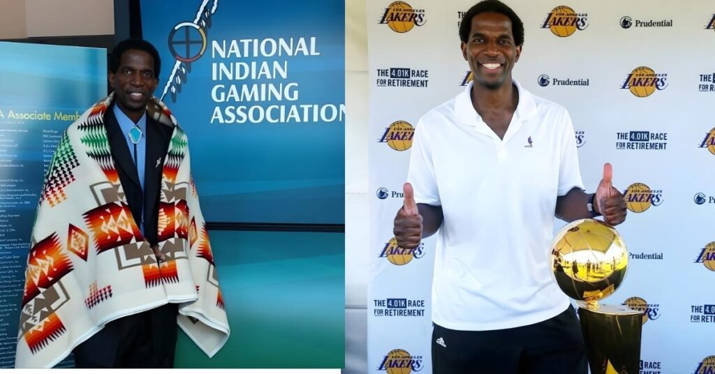 Standing in front of a Lakers-themed backdrop with the NBA trophy, someone gives two thumbs up.