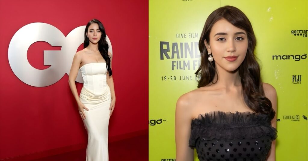 Caylee Cowan, in a black strapless dress with heart patterns, stands in front of a lime green backdrop with text that reads RAINBOW FILM FESTIVAL.