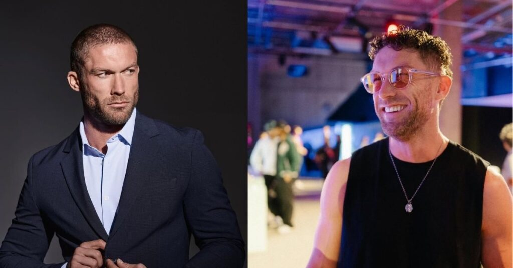 Chris Williamson, in a dark blue suit and light blue dress shirt adjusts the button on his jacket.