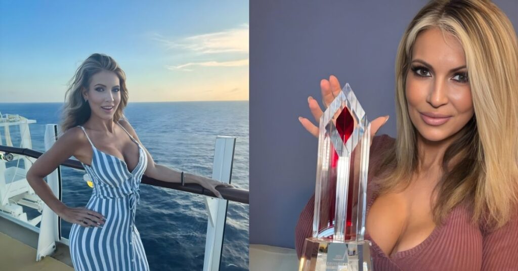 Gigi Dior holds up a tall, clear crystal award with a red gem at the top and an engraved base that reads Gigi Dier.