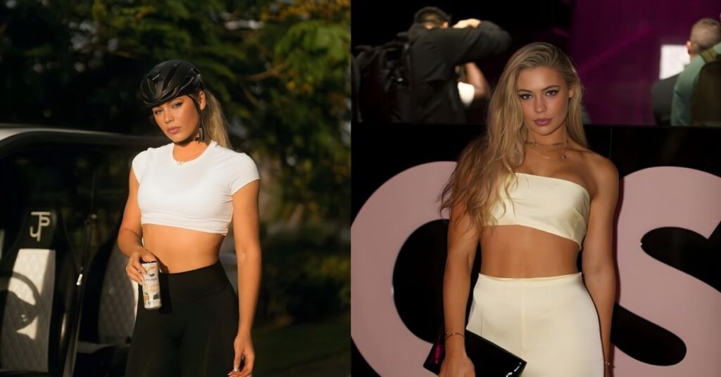 Jutta Leerdam, in a white crop top, black leggings, and a black helmet, holds a can while standing next to a vehicle.