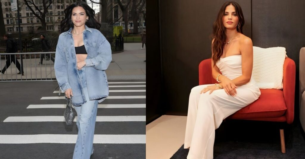Jenna Dewan, wearing a white strapless jumpsuit and jewelry, sits on a red armchair against a dark wall.