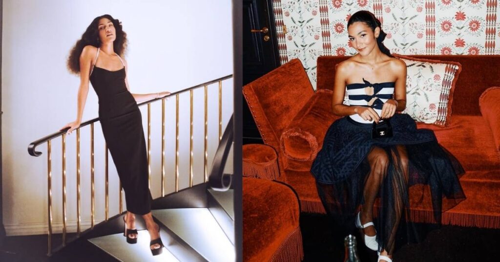 Olivia Dean, in a black dress with diamond straps, leans on a gold railing on a modern staircase.