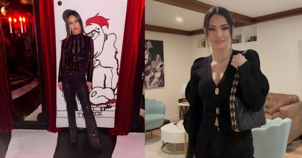 Sandra Vergara stands in a sequined outfit in front of a large black and white drawing of a caricature with red accents.