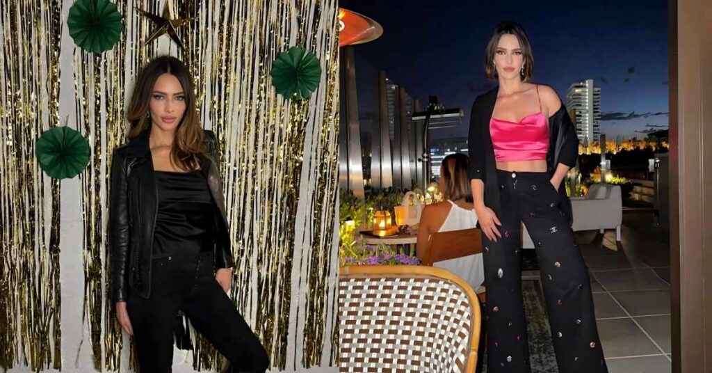 Sandra Vergara stands in front of a gold fringe backdrop with green paper fans and a gold star decoration.