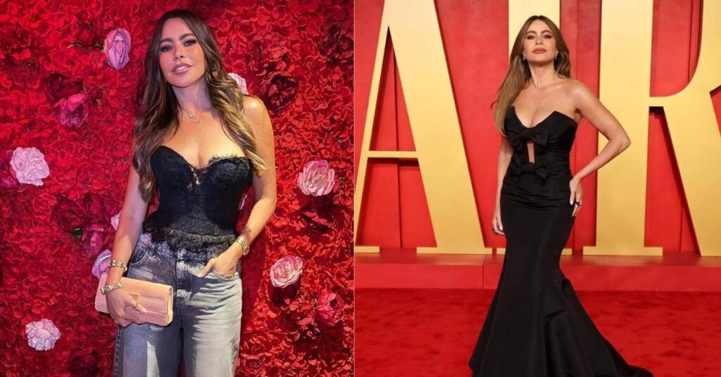 Sofia Vergara, in a black strapless gown with two bows on the bodice, stands on a red carpet in front of a gold and red backdrop.