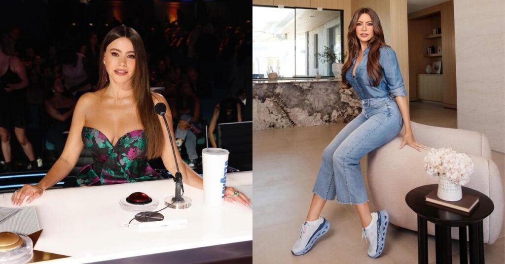 Sofia Vergara wearing a denim shirt, flared jeans, and white and blue sneakers sits on a cream-colored armchair in a modern living room.