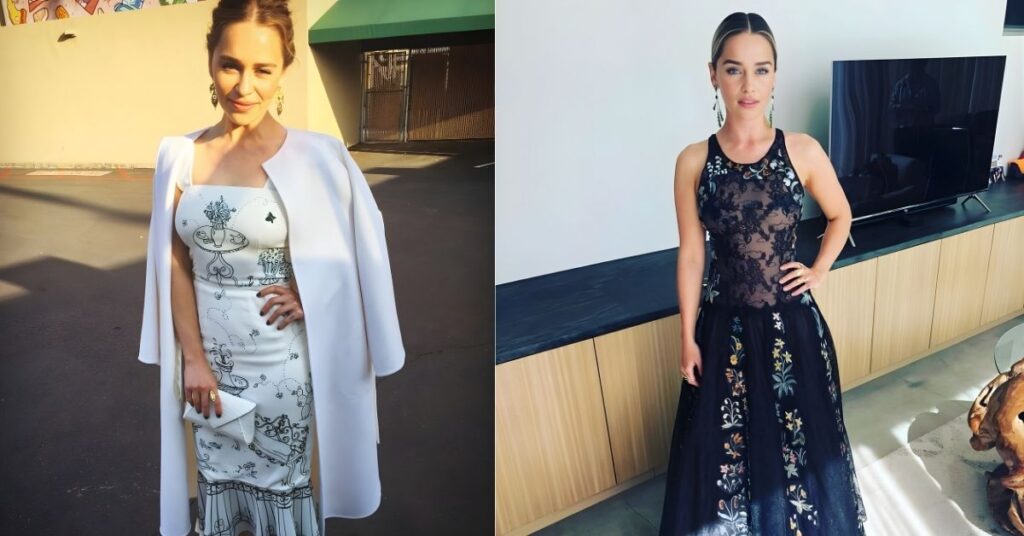 Emilia Clarke, in a sleeveless black gown with intricate floral embroidery, stands with her hand on her hip.