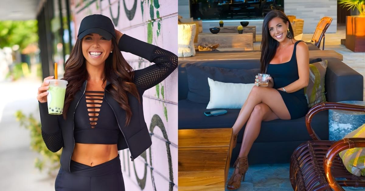 A person in a black dress sits on a dark couch holding a drink and wearing strappy heels.