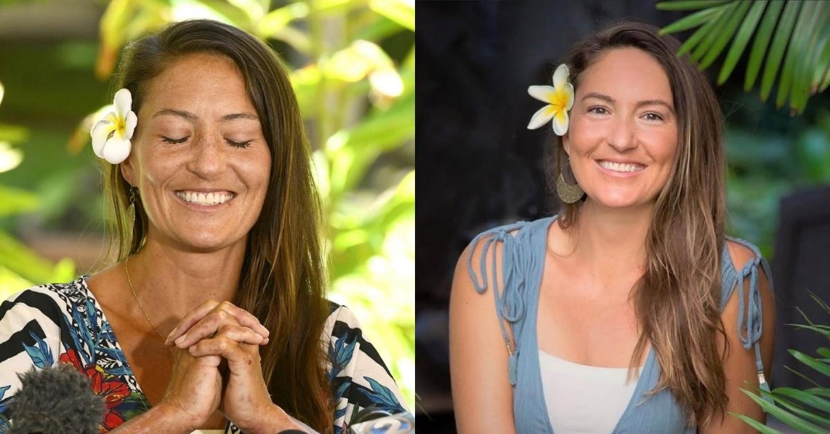 Amanda Elle with a white plumeria flower tucked behind her ear smiles at the camera. She is wearing a blue dress over a white top and has long, wavy brown hair. Large, golden earrings adorn her ea