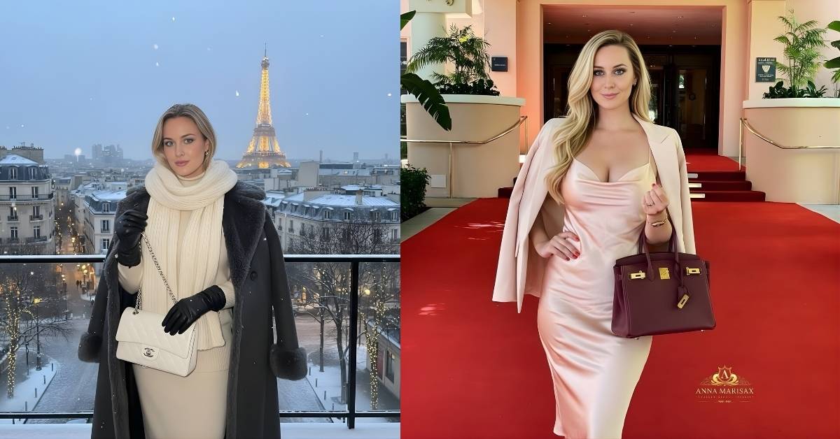 Anna Marisax, wearing a light pink satin slip dress and a matching blazer, stands on a red carpet, holding a burgundy handbag.