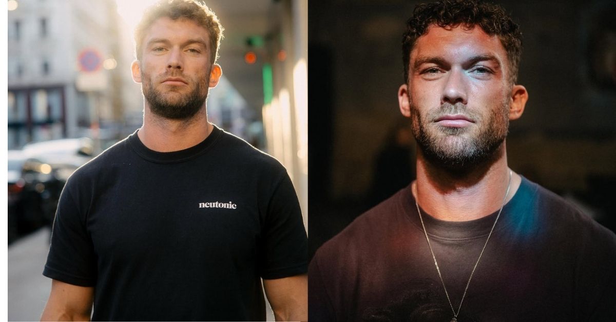 Chris Williamson with curly dark hair and a beard, wearing a dark t-shirt and a silver necklace.