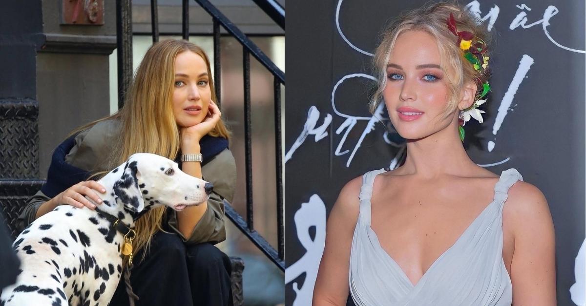 Jennifer Lawrence has blonde hair styled with colorful flowers and leaves, wearing a pale blue dress with a deep V-neckline.