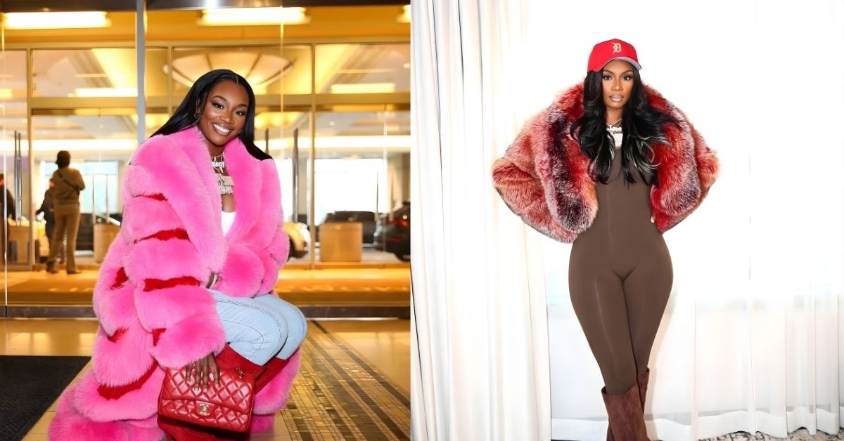 Claressa Shields, wearing a long, fluffy pink coat with red stripes, light blue jeans, red boots, and holding a red quilted purse.