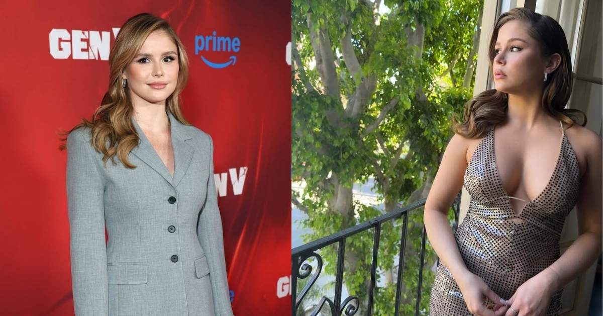 Erin Moriarty, in a shimmering gold halter dress, stands on a balcony with lush green trees visible in the background.