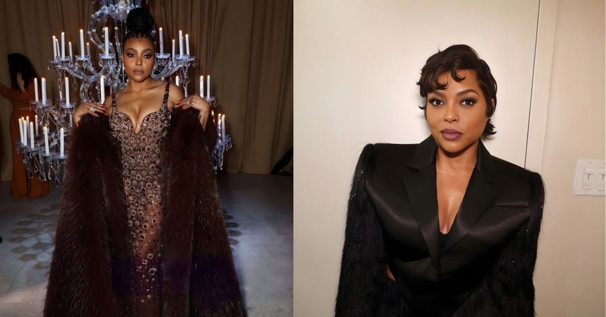 Taraji P. Henson, wearing a black suit with feathered sleeves and a plunging neckline, standing against a white wall.