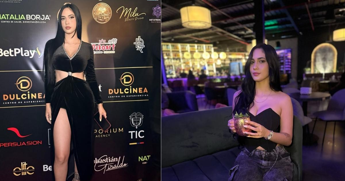 Florizqueen, in a black velvet dress with cutouts and a high slit, stands on a red carpet in front of a backdrop with sponsor logos.